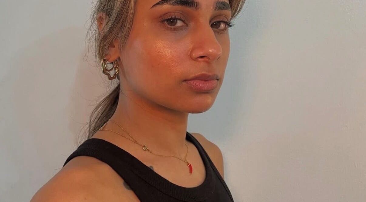 Model showcasing radiant skin and bold brows at Brow Capital, London, England, GB.