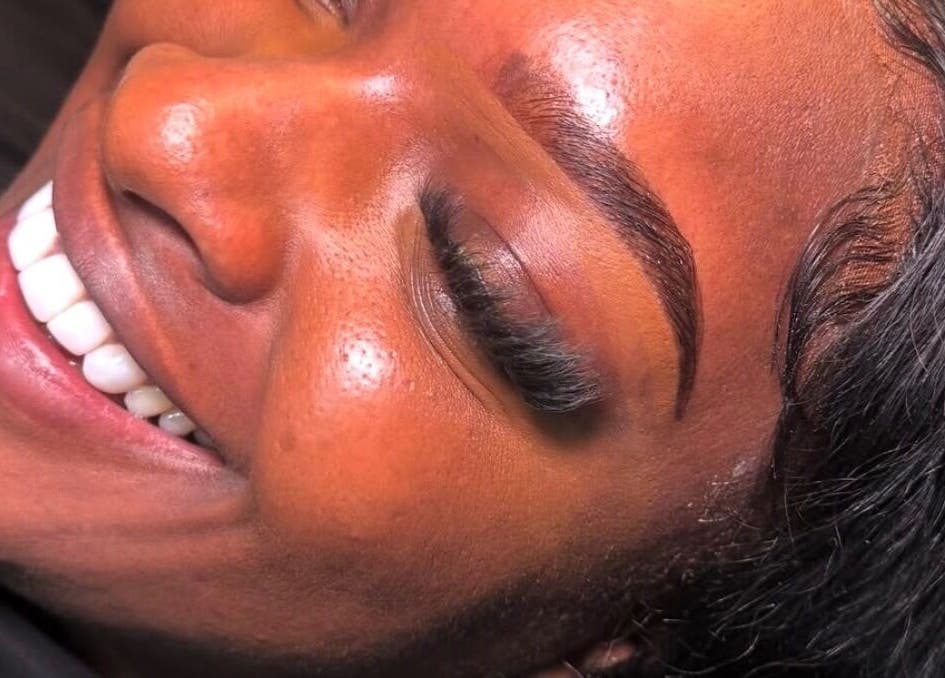 Close-up of radiant brows after treatment at Brow Capital, London, England, GB. Client smiles joyfully.