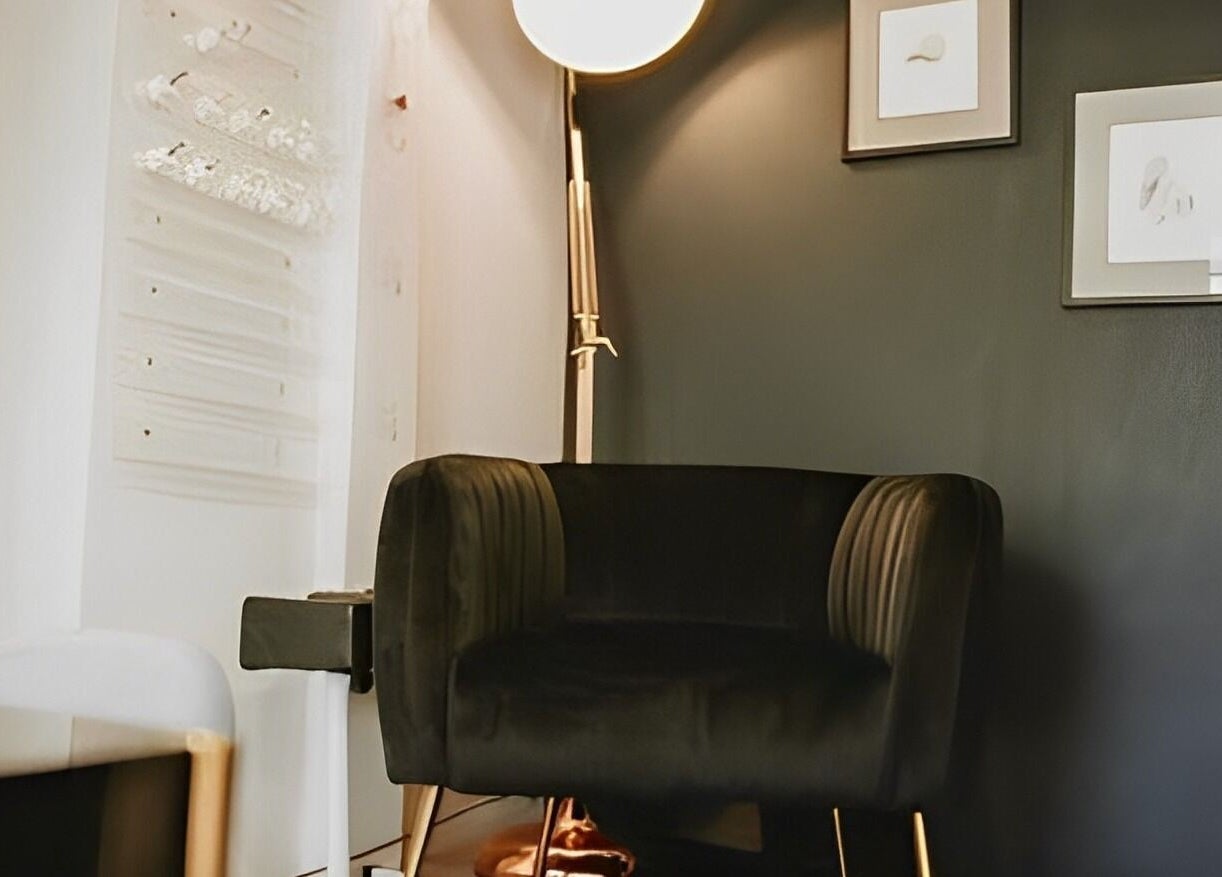 Chic, cozy corner at Bethan Sian, Malton. Modern chair with wall art and lighting in Malton, England, GB.