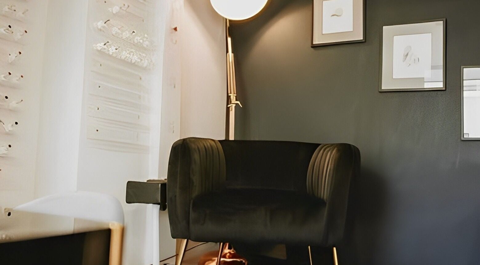 Chic, cozy corner at Bethan Sian, Malton. Modern chair with wall art and lighting in Malton, England, GB.