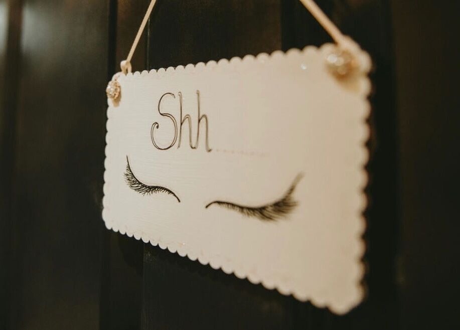 A calming 'Shh' sign with closed eyelashes at Bethan Sian, Malton, England, GB.