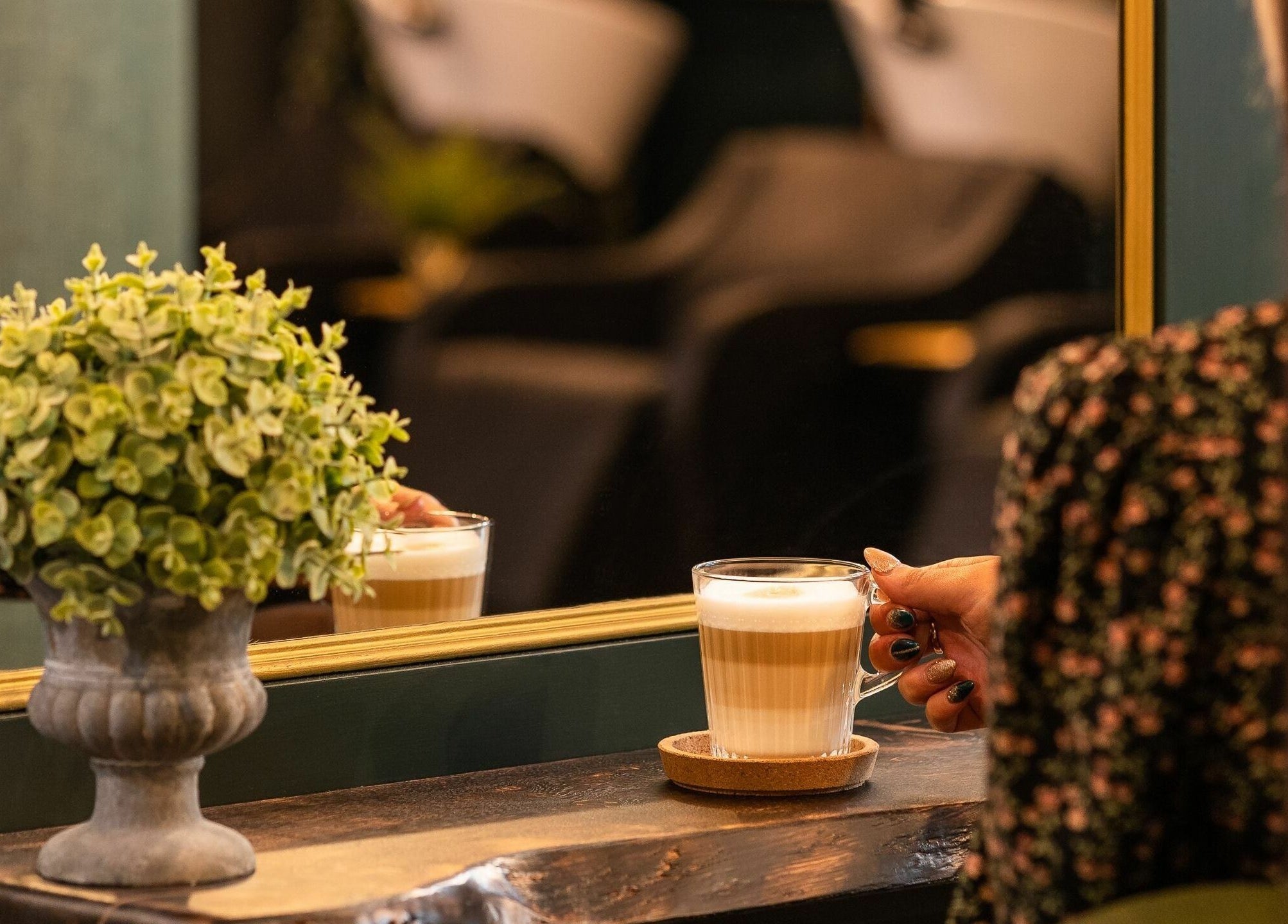 Chic interior with latte and plant at Hygge Luxury Salon Omagh, Omagh, Northern Ireland, GB.