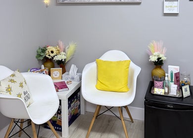 Cozy waiting area at Sunshine Aesthetics with chairs and decor in Roseville, Minnesota, US.
