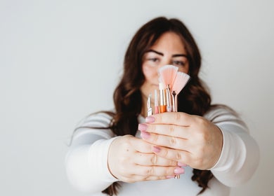 Woman holding beauty tools at Sunshine Aesthetics in Roseville, Minnesota, US, showcasing salon services.