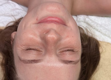 A woman enjoys a facial treatment at Sunshine Aesthetics in Roseville, Minnesota, US for a radiant skin glow.