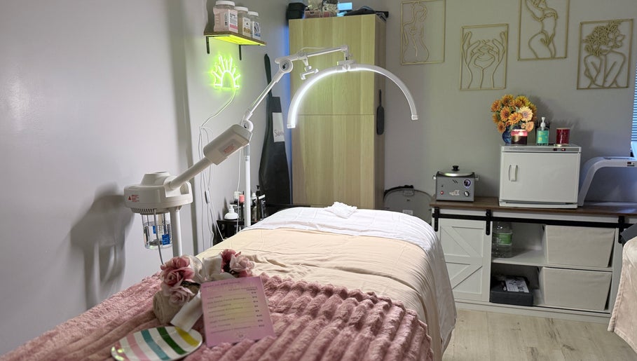 Relaxing spa room at Sunshine Aesthetics in Roseville, Minnesota, US, featuring a treatment bed and calming decor.