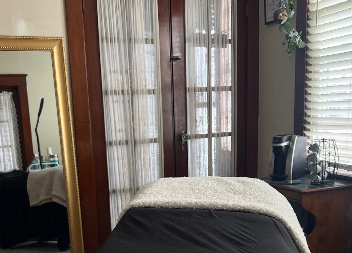 Cozy treatment room at Artistry By Alex, Westerly, Rhode Island, US, with a treatment bed and elegant decor.