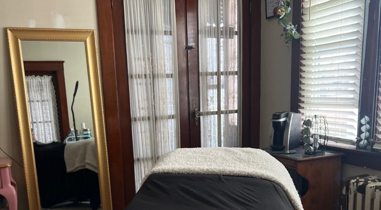 Cozy treatment room at Artistry By Alex, Westerly, Rhode Island, US, with a treatment bed and elegant decor.