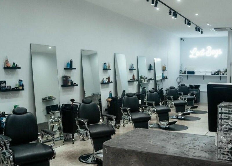 Modern interior of Lost Boys Burleigh salon in Burleigh Heads, Queensland, AU with sleek chairs and mirrors.