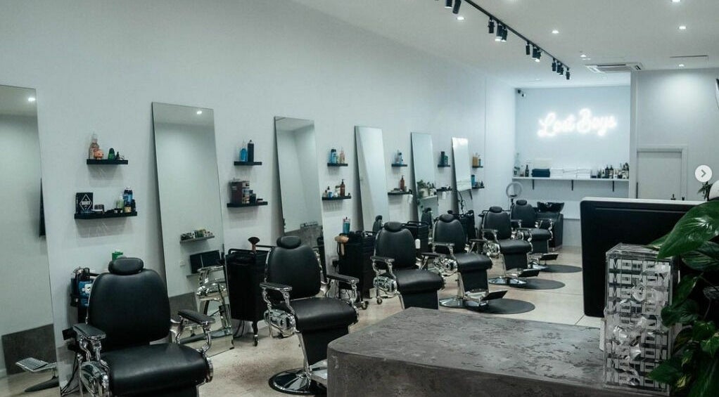 Modern interior of Lost Boys Burleigh salon in Burleigh Heads, Queensland, AU with sleek chairs and mirrors.