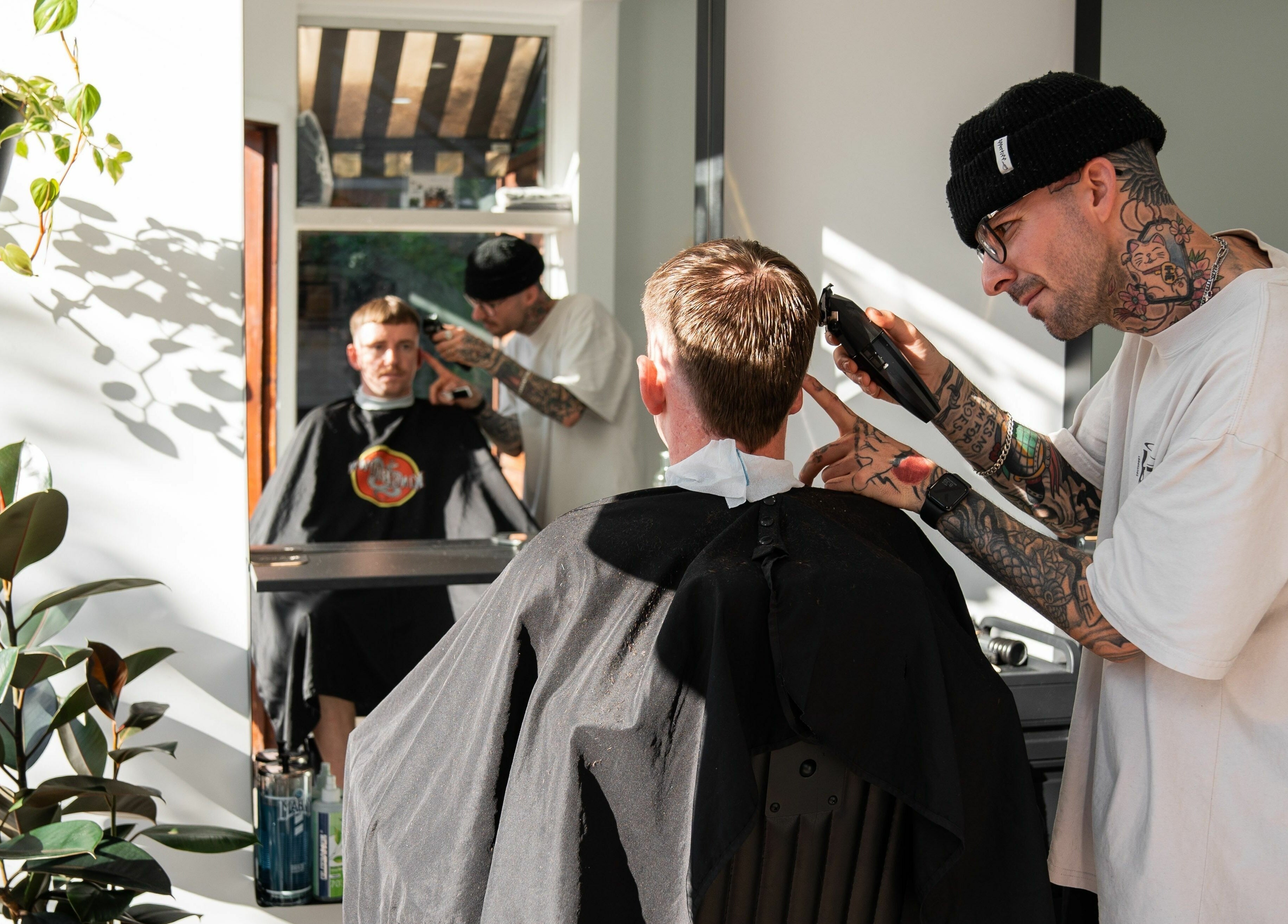 Stylist at Lost Boys Burleigh in Burleigh Heads, Queensland, AU, expertly cutting client's hair.