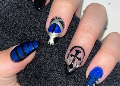 Intricate nail art with blue and black designs at Cruella De Nails, Langebaan, Western Cape, ZA.
