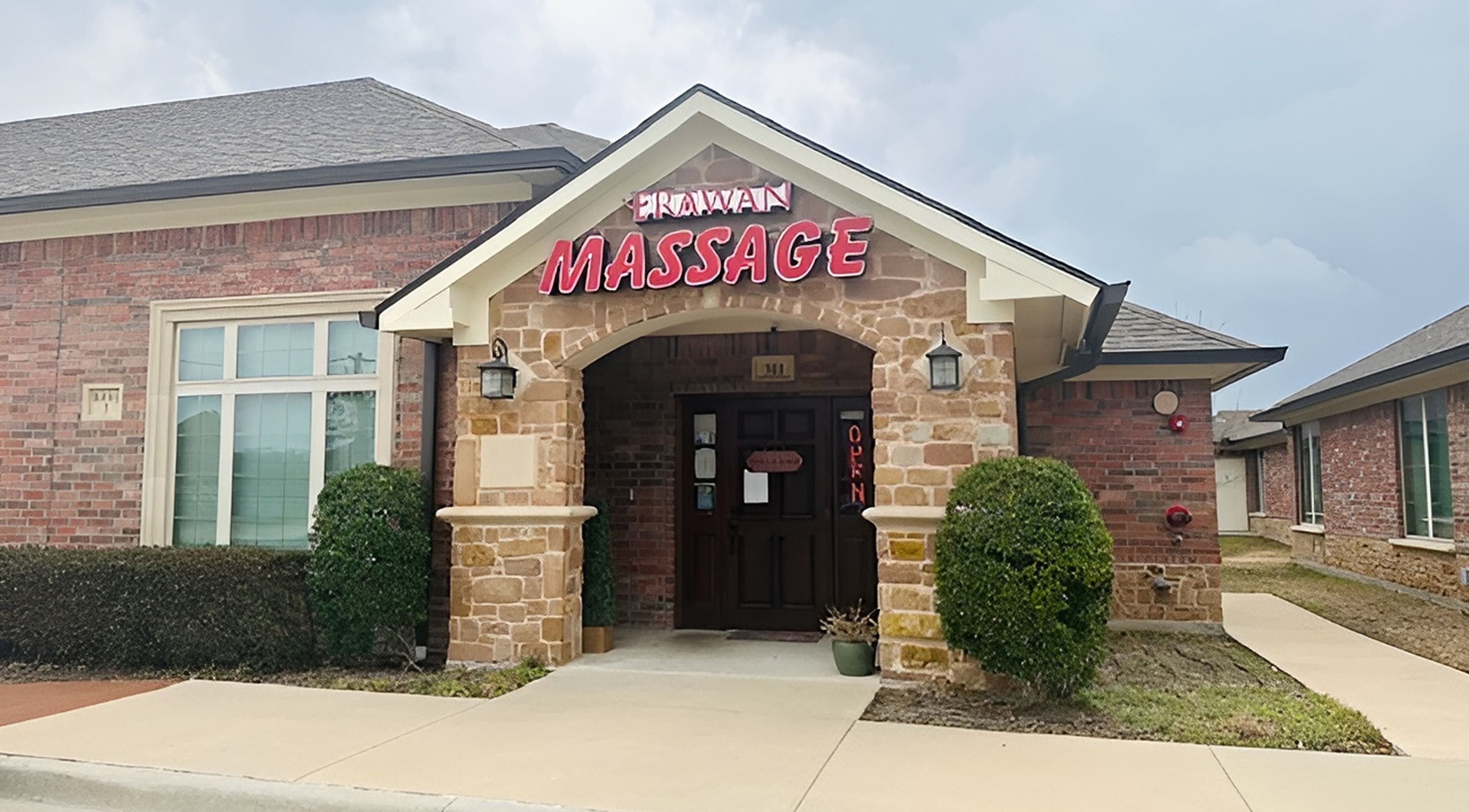 Entrance of Erawan Thai Massage at Frisco, showcasing inviting stone and brick facade, Frisco, Texas, US.