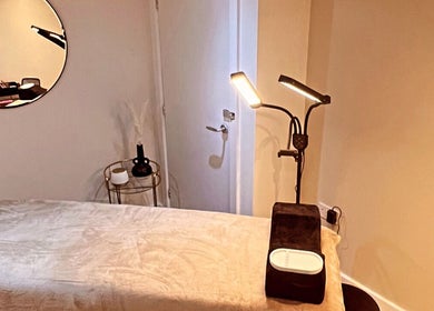 Calm therapy room at Aphrodite Lash, Worsbrough, England, GB, featuring cozy lighting and a treatment bed.