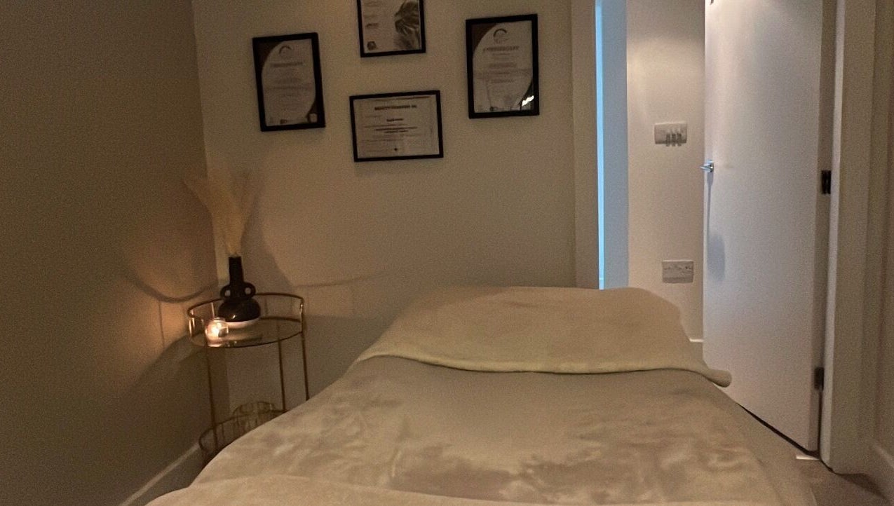 Calm treatment room at Aphrodite Lash, Worsbrough, England, GB with cozy bed and ambient lighting.