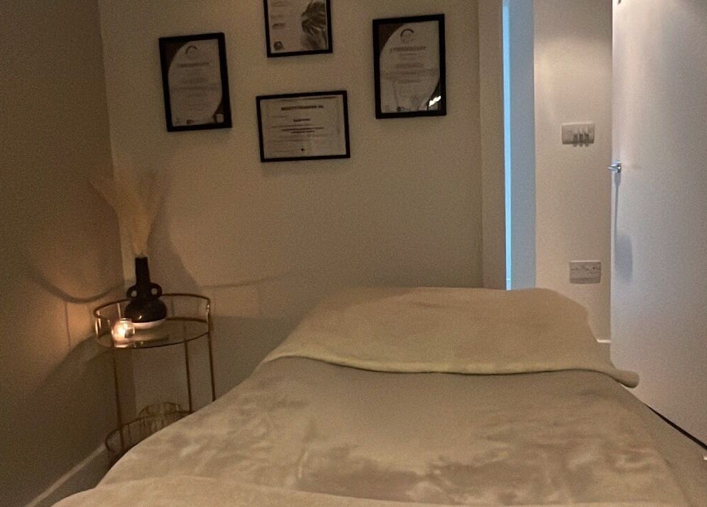 Calm treatment room at Aphrodite Lash, Worsbrough, England, GB with cozy bed and ambient lighting.