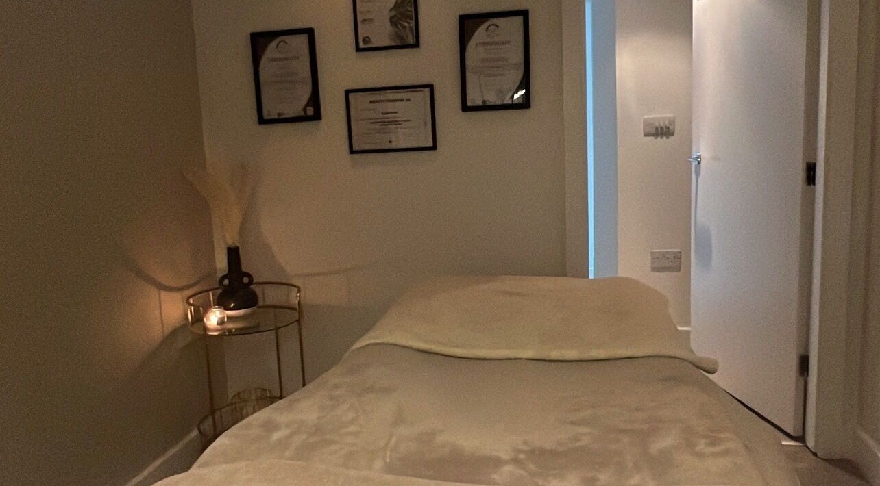 Calm treatment room at Aphrodite Lash, Worsbrough, England, GB with cozy bed and ambient lighting.