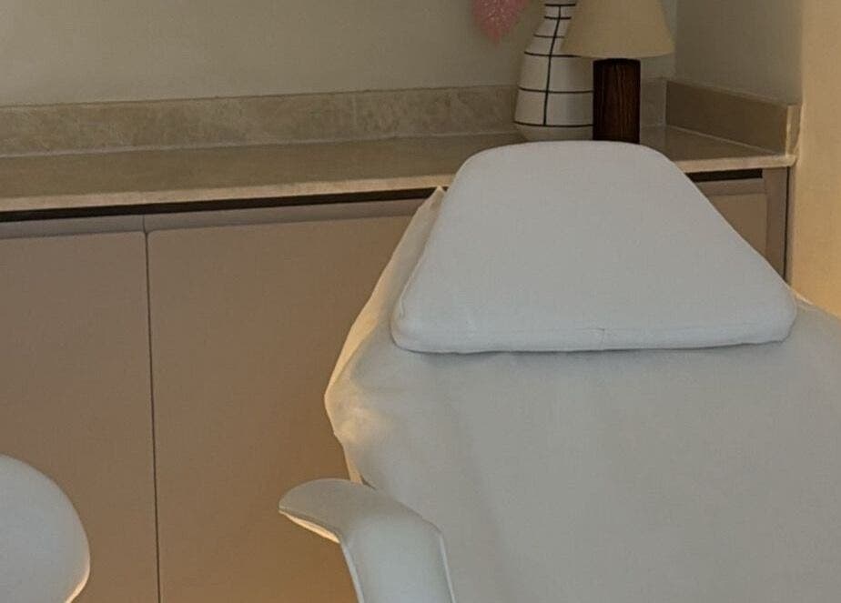 Relaxing treatment room at Ray Spa Beauty Center in Al Ain, Abu Dhabi, AE, featuring a comfortable massage table.