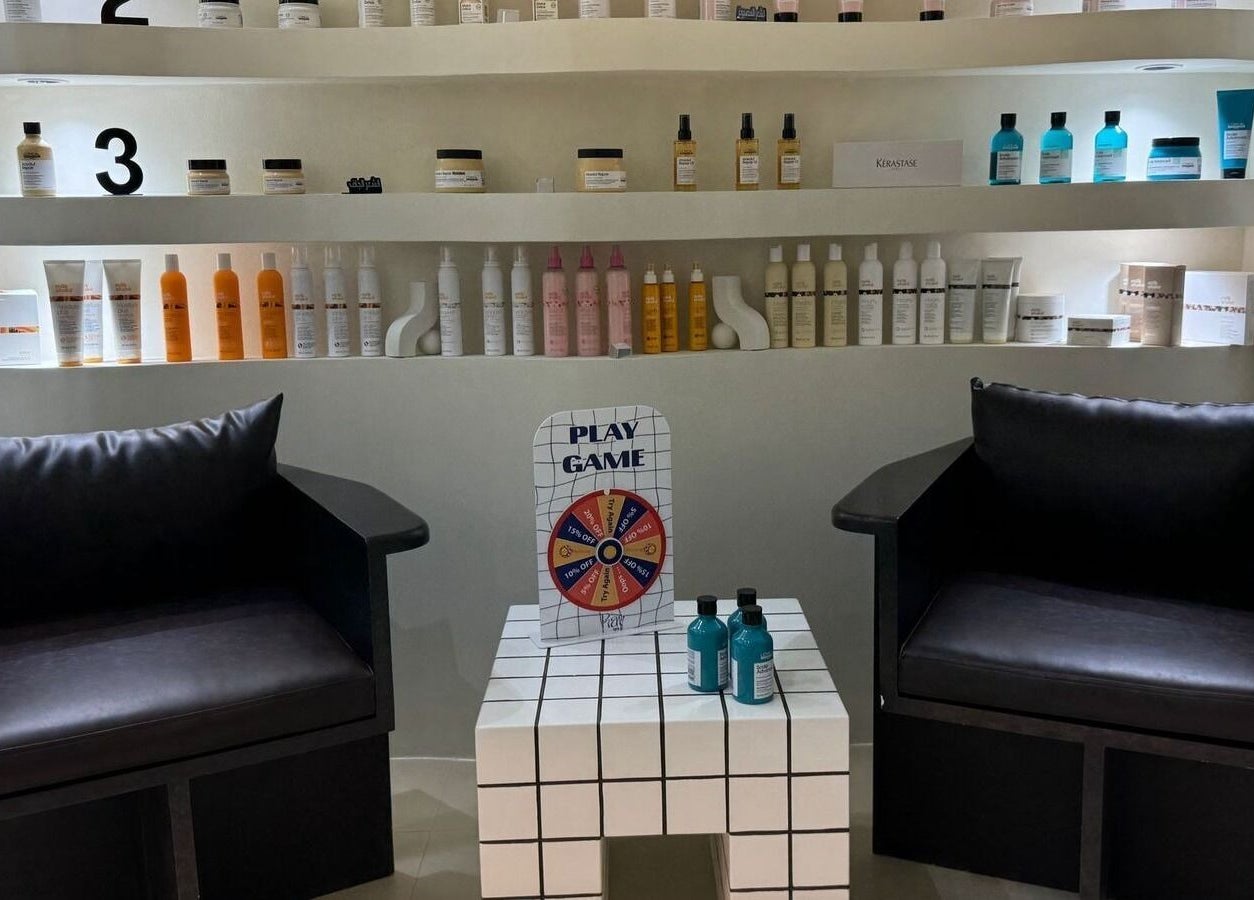 Cozy seating area at Ray Spa Beauty Center in Al Ain, Abu Dhabi, AE with elegant beauty products displayed.