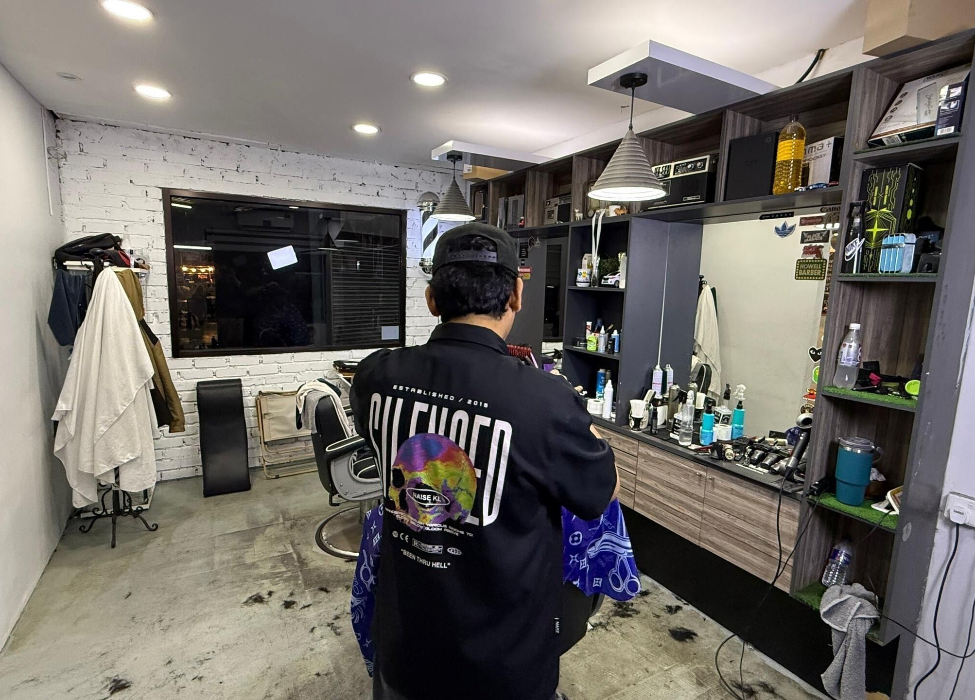 Interior view of Brothers Barbershop Tiram in Ulu Tiram, Johor, MY, showcasing modern barber station.