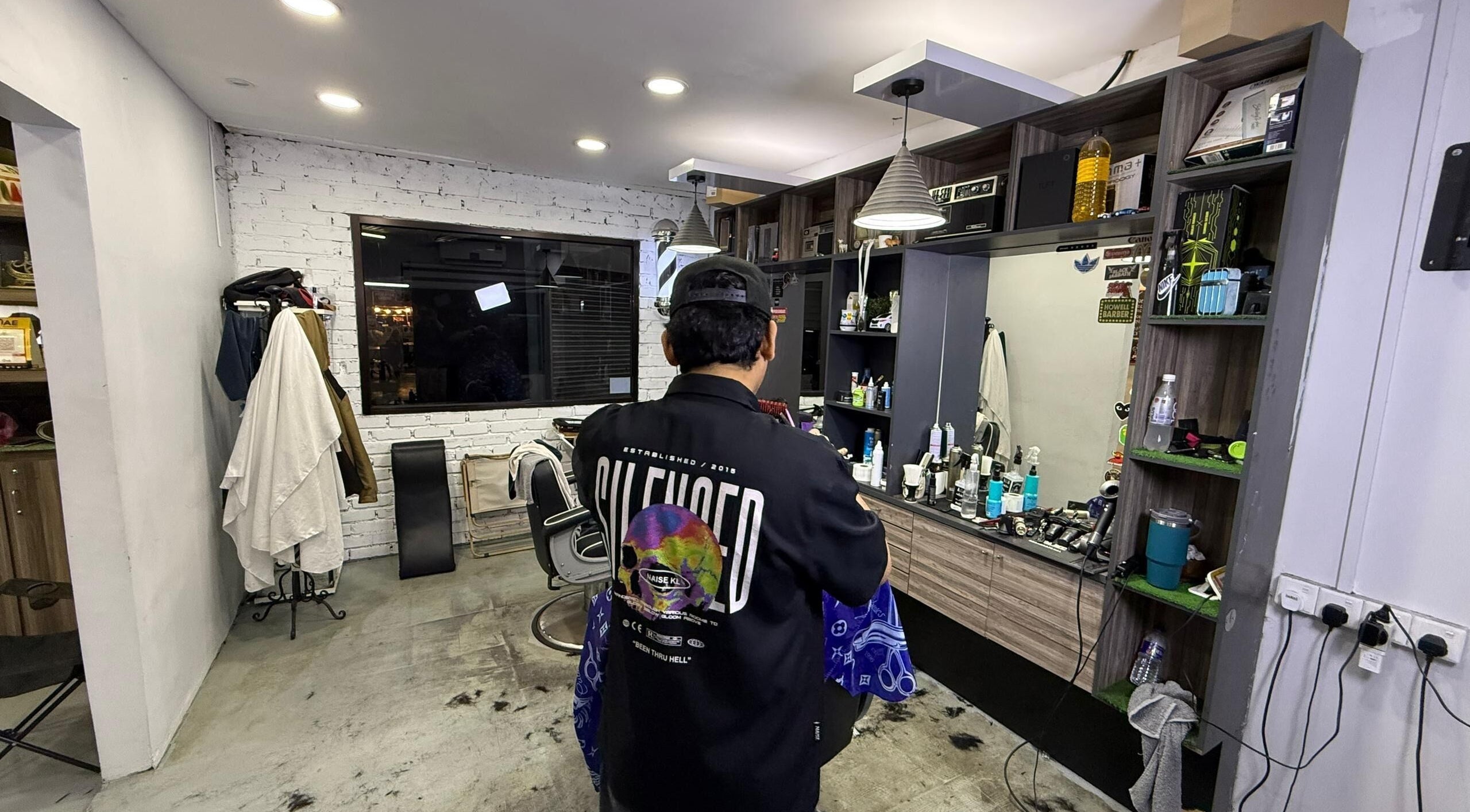 Interior view of Brothers Barbershop Tiram in Ulu Tiram, Johor, MY, showcasing modern barber station.