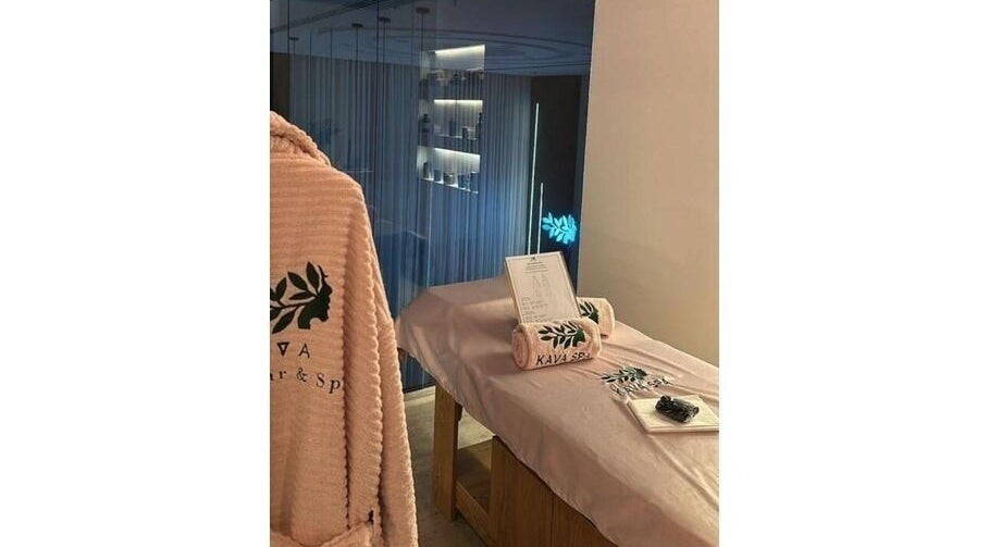 Relaxing spa room at KAVA Hairbar | كافا هيربار, Riyadh, Riyadh Province, SA with robe and massage table.