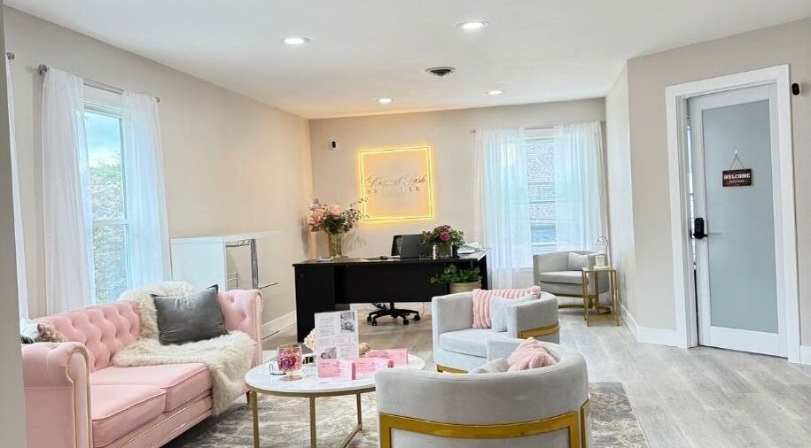 Elegant reception at Natural Lash Skin Bar, Northville, Michigan, US with pink sofas and soft lighting.