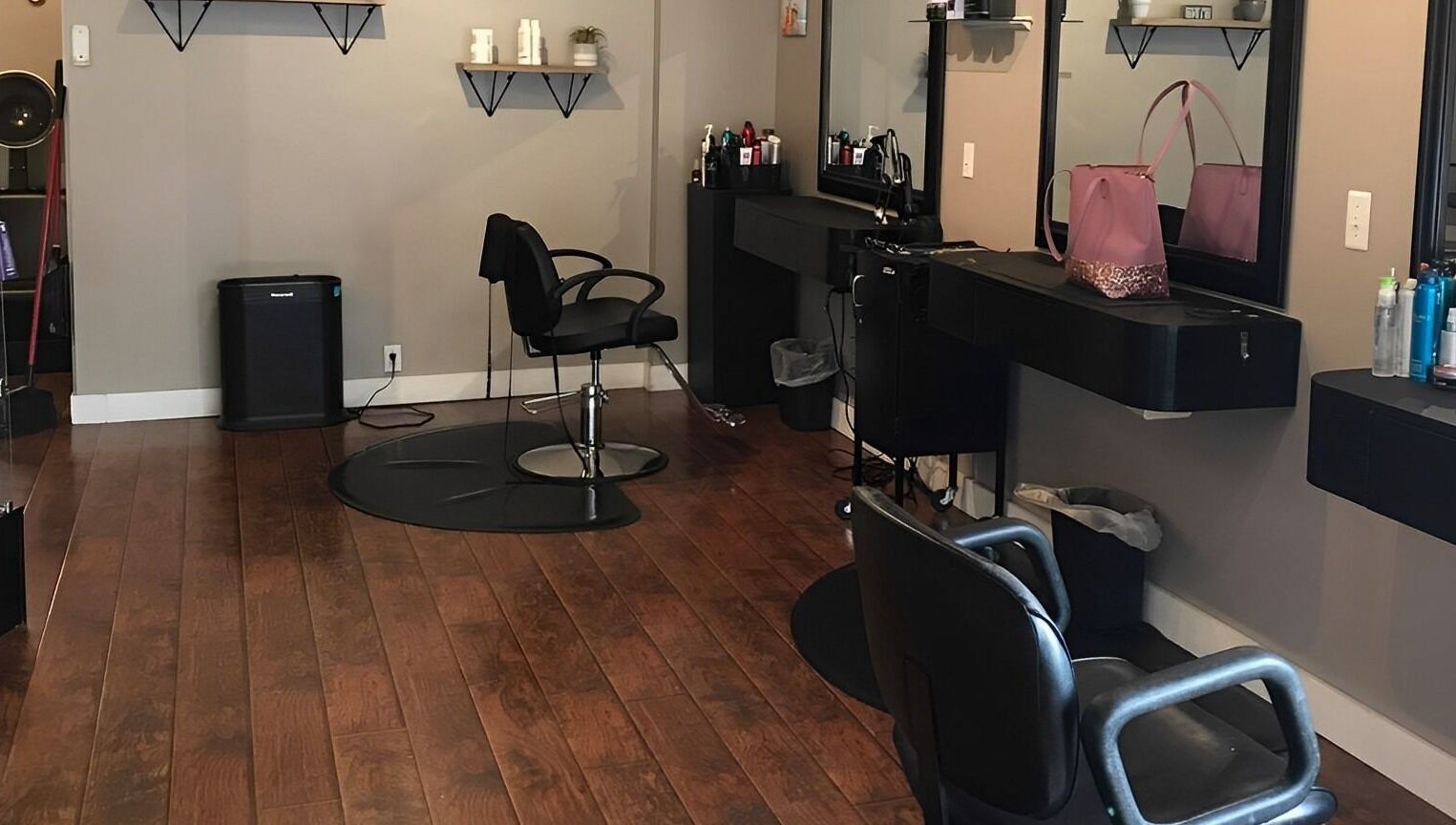 Modern salon interior at Scissor Excitement, Hampden, Maine, US with stylish chairs and shelving.