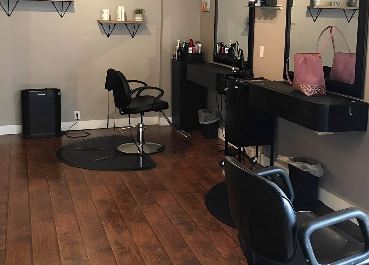 Modern salon interior at Scissor Excitement, Hampden, Maine, US with stylish chairs and shelving.