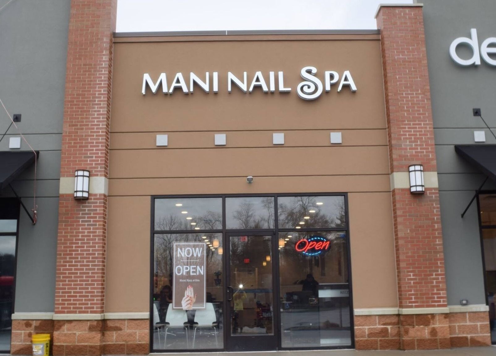 Exterior view of Mani Nails & Spa in Bethel Park, Pennsylvania, US, with open sign displayed.