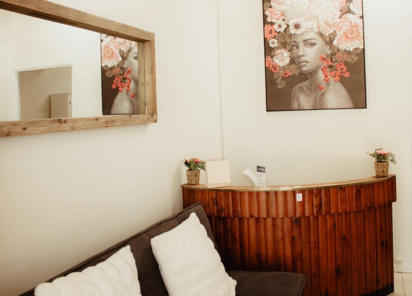 Elegant wooden reception with artwork at Refresh and Reveal Cosmetic Skin Clinic- Chinchilla, Queensland, AU.