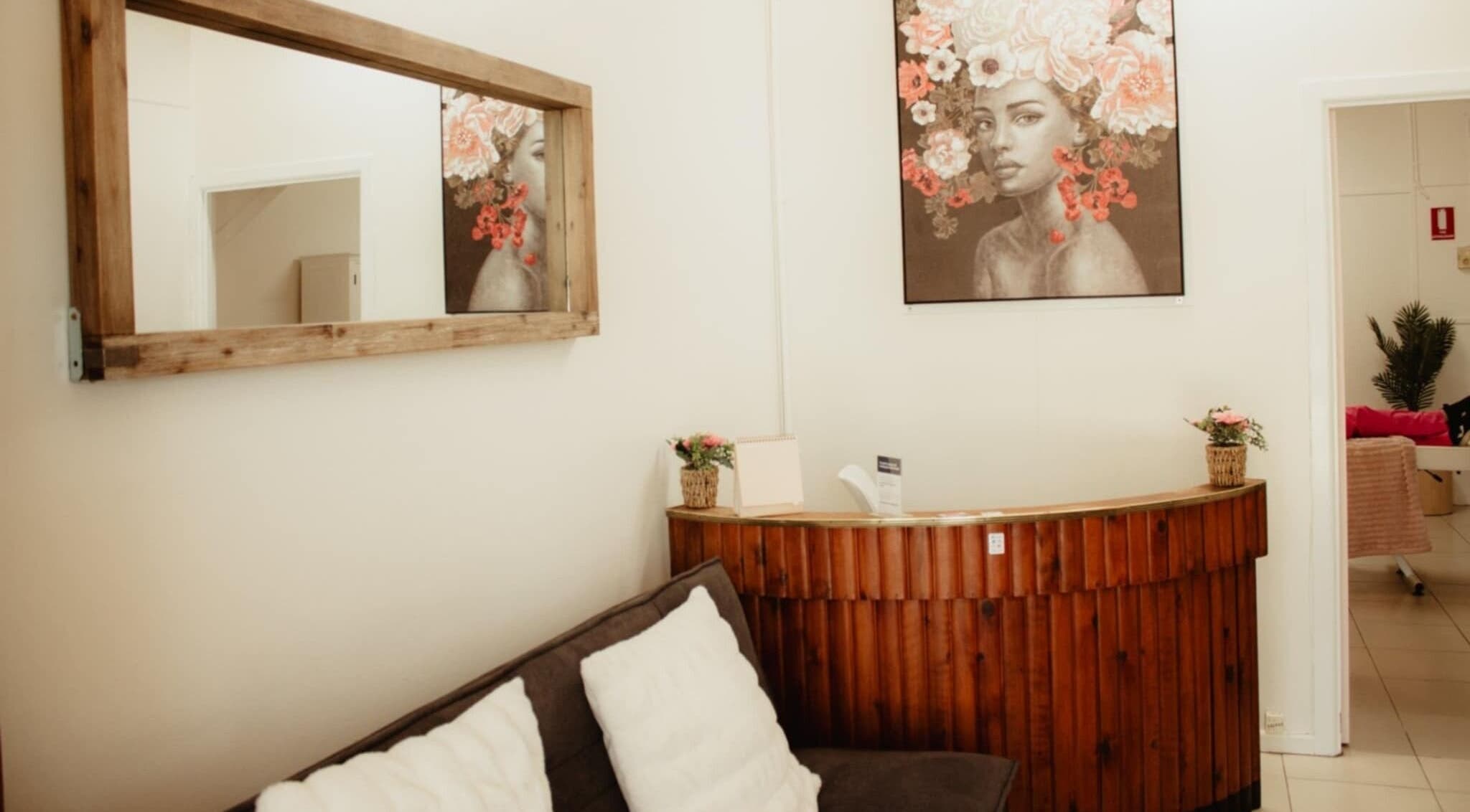 Elegant wooden reception with artwork at Refresh and Reveal Cosmetic Skin Clinic- Chinchilla, Queensland, AU.