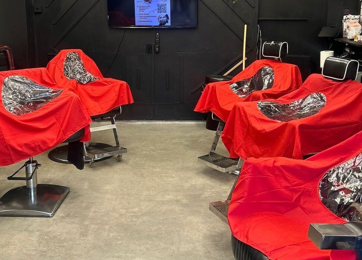 Barber Stop's sleek interior showcases red-covered chairs in Birmingham, England, GB.