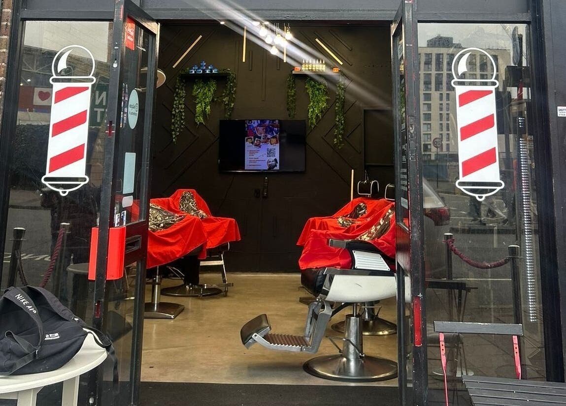 Interior view of Barber Stop, Birmingham, England, GB, showcasing modern barber chairs and stylish decor.