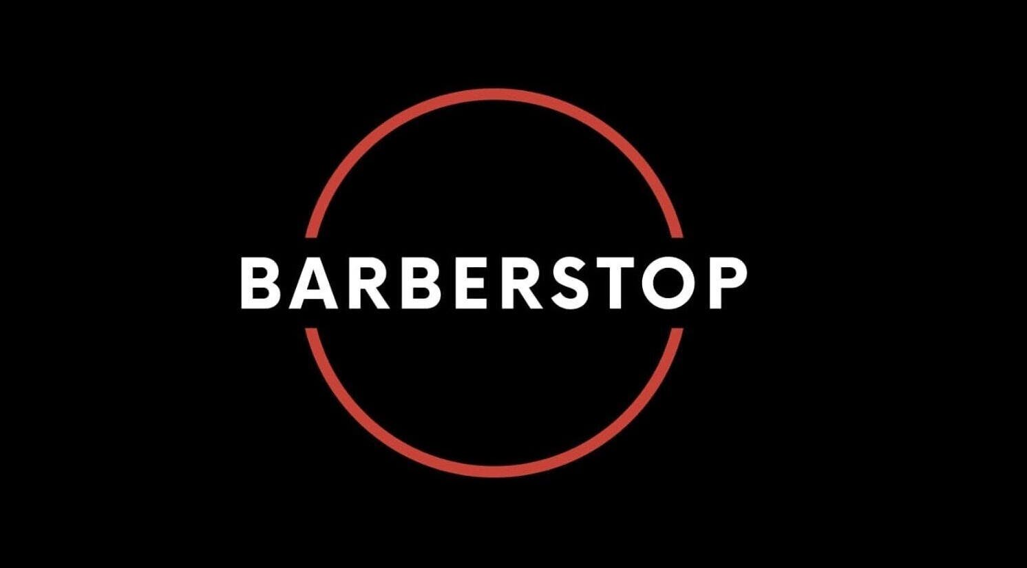 Elegant Barber Stop logo on black background, Birmingham, England, GB.