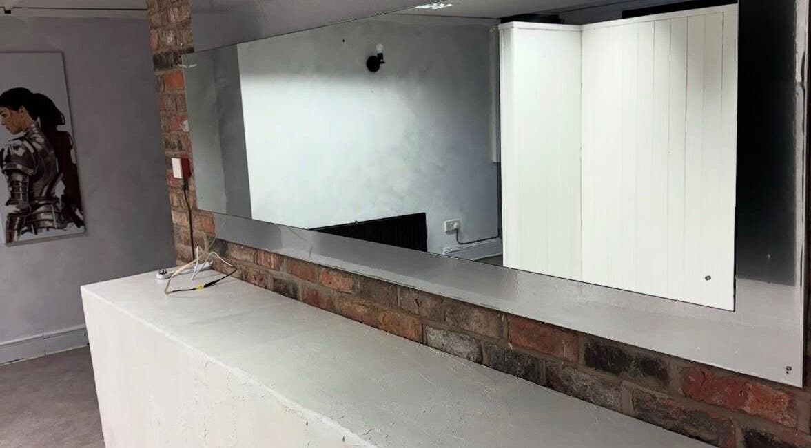 Modern wall mirror at Demi The Hairdresser, Manchester, England, GB showcasing sleek salon design.