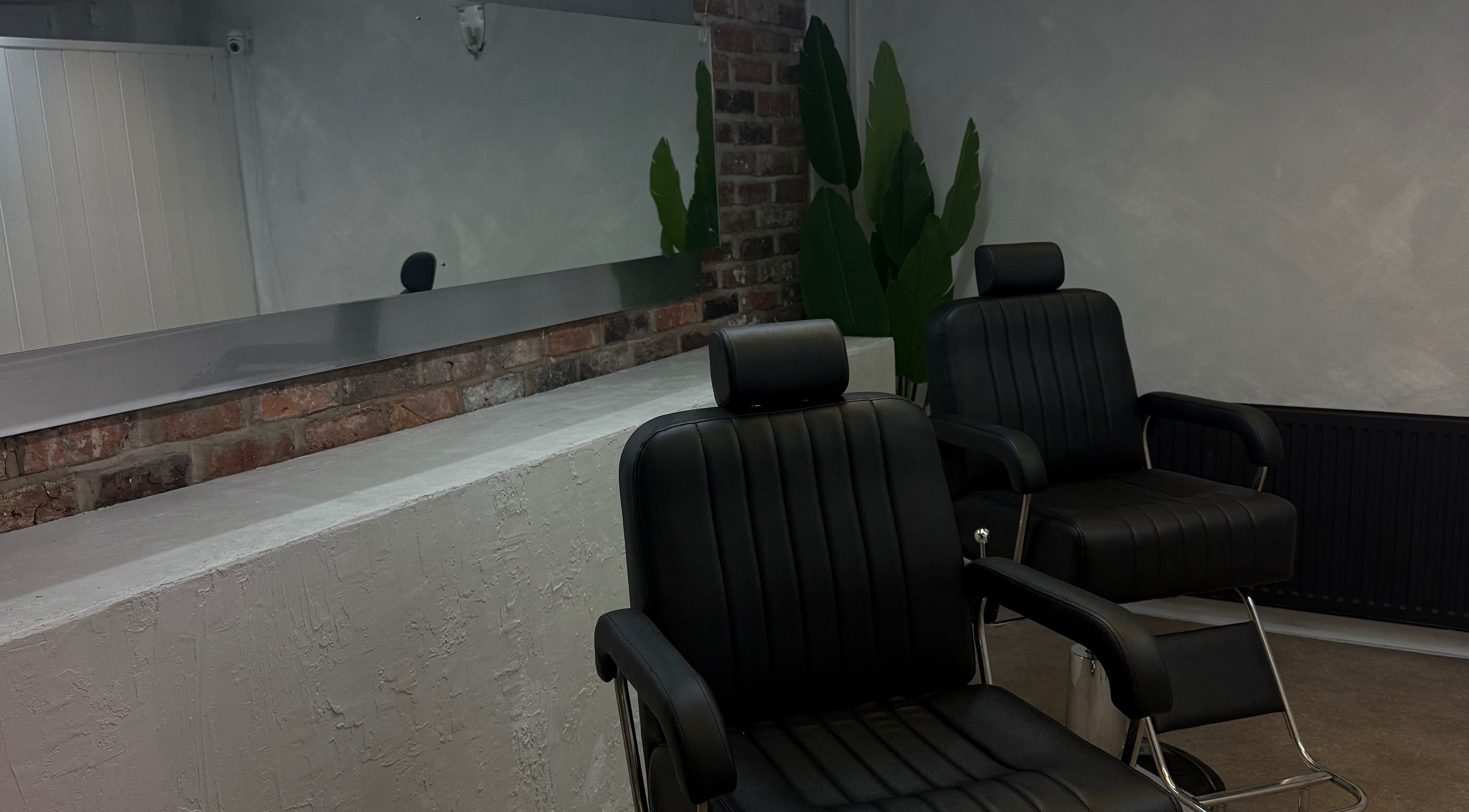 Modern salon chairs at Demi The Hairdresser in Manchester, England, GB, featuring sleek design and comfort.