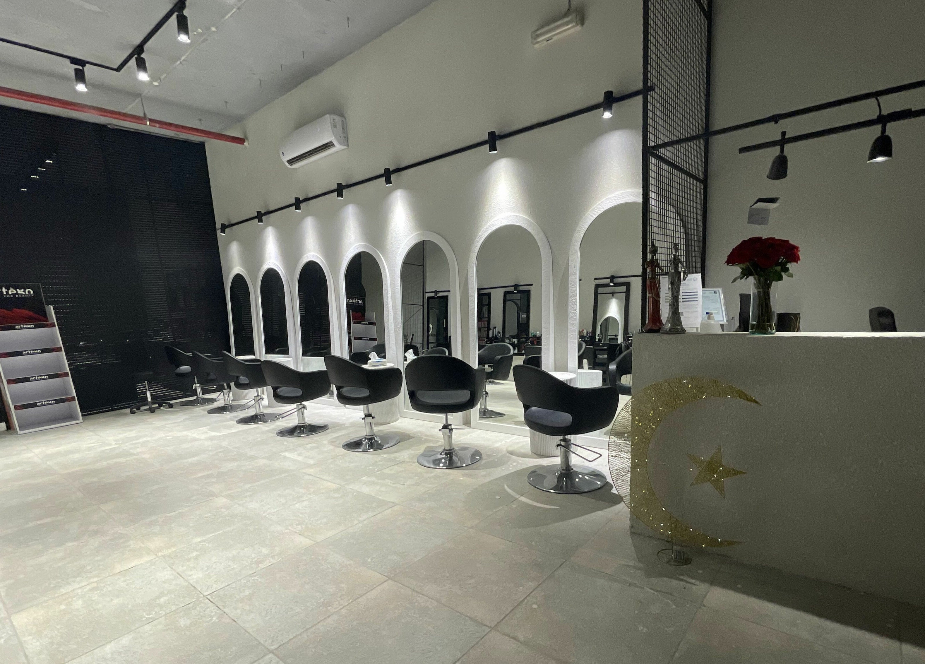 Chic salon interior at The Golden Hour, Riyadh, Riyadh Province, SA with sleek black seating and stylish mirrors.