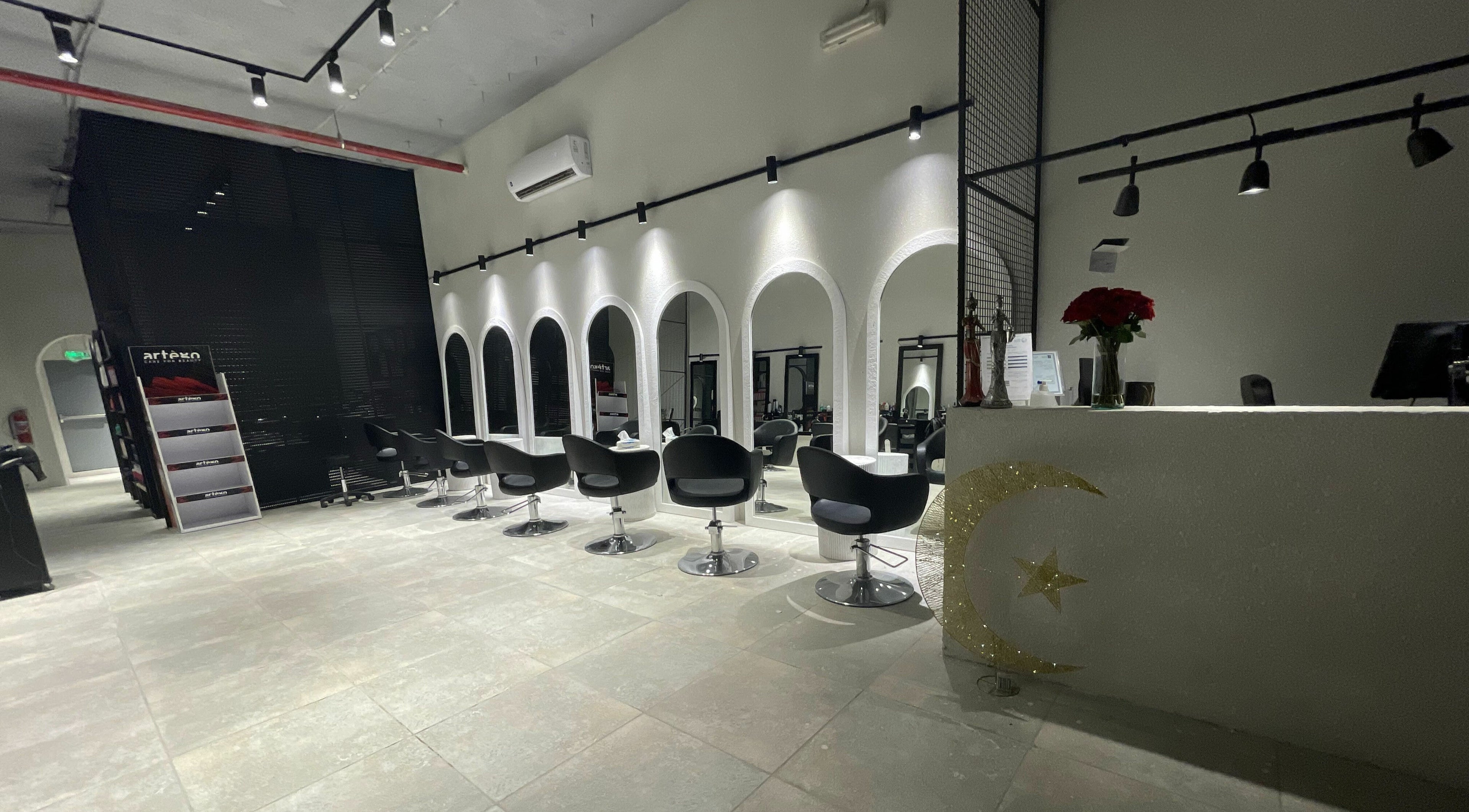 Chic salon interior at The Golden Hour, Riyadh, Riyadh Province, SA with sleek black seating and stylish mirrors.