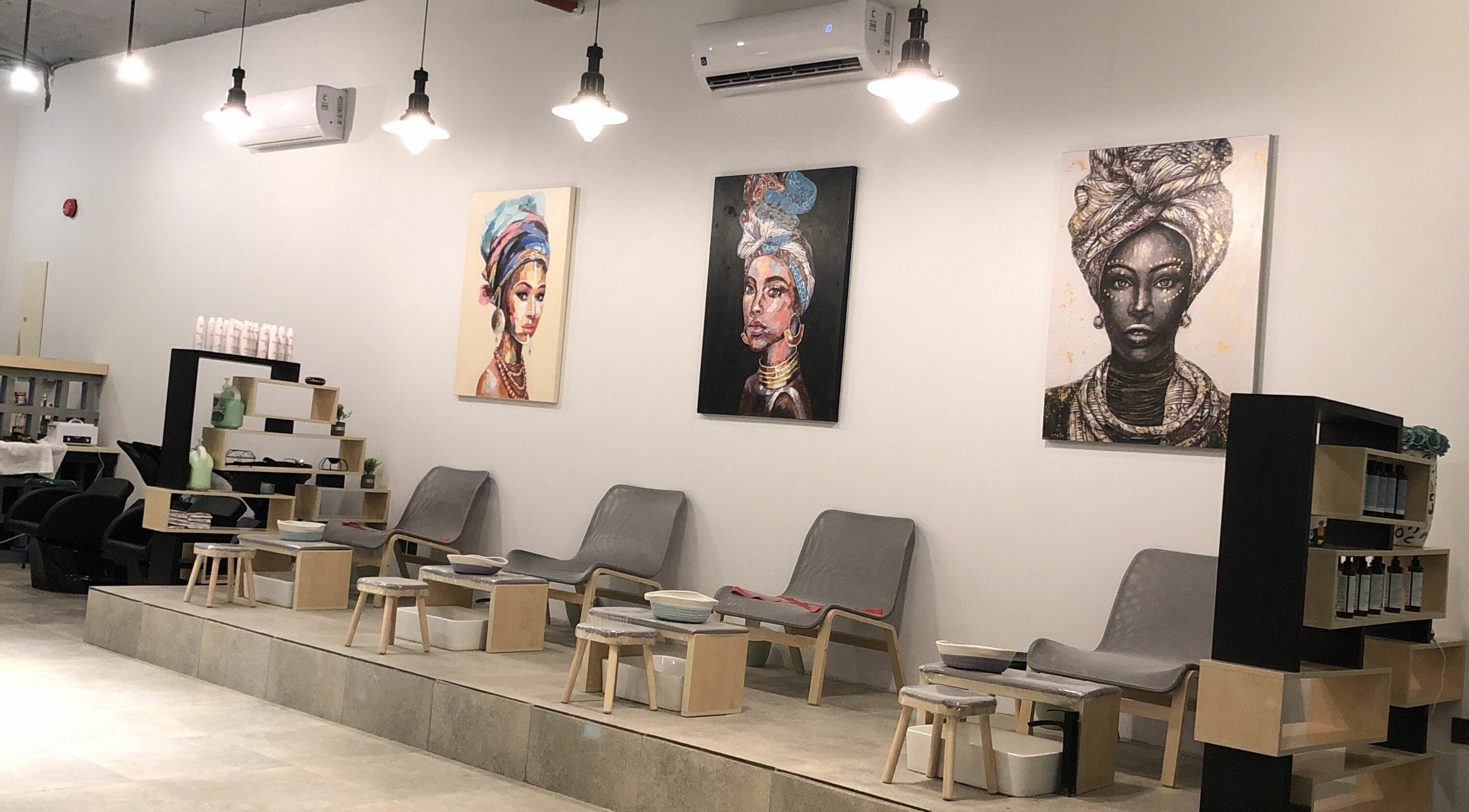 Modern lounge area at The Golden Hour, Riyadh, Riyadh Province, SA, with elegant chairs and vibrant artwork.