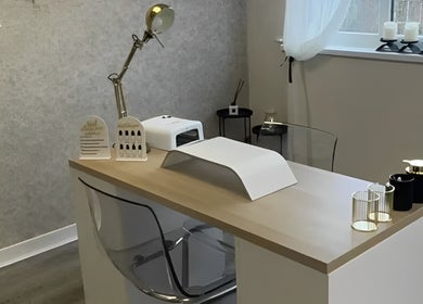 Elegant salon desk setup at The Lash Firm, Consett, England, GB, featuring nail care tools and modern decor.