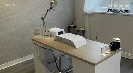 Elegant salon desk setup at The Lash Firm, Consett, England, GB, featuring nail care tools and modern decor.