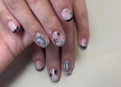 Creative star-themed nail art at The Lash Firm, Consett, England, GB. Features glossy finishes and black accents.