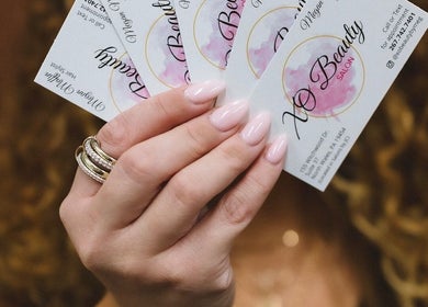 Elegant nails holding Xo Beauty business cards, North Wales, Pennsylvania, US.