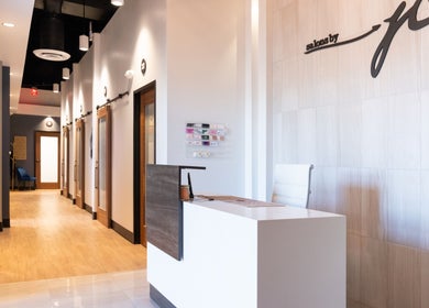 Reception area at Xo Beauty in North Wales, Pennsylvania, US with modern decor and warm lighting.