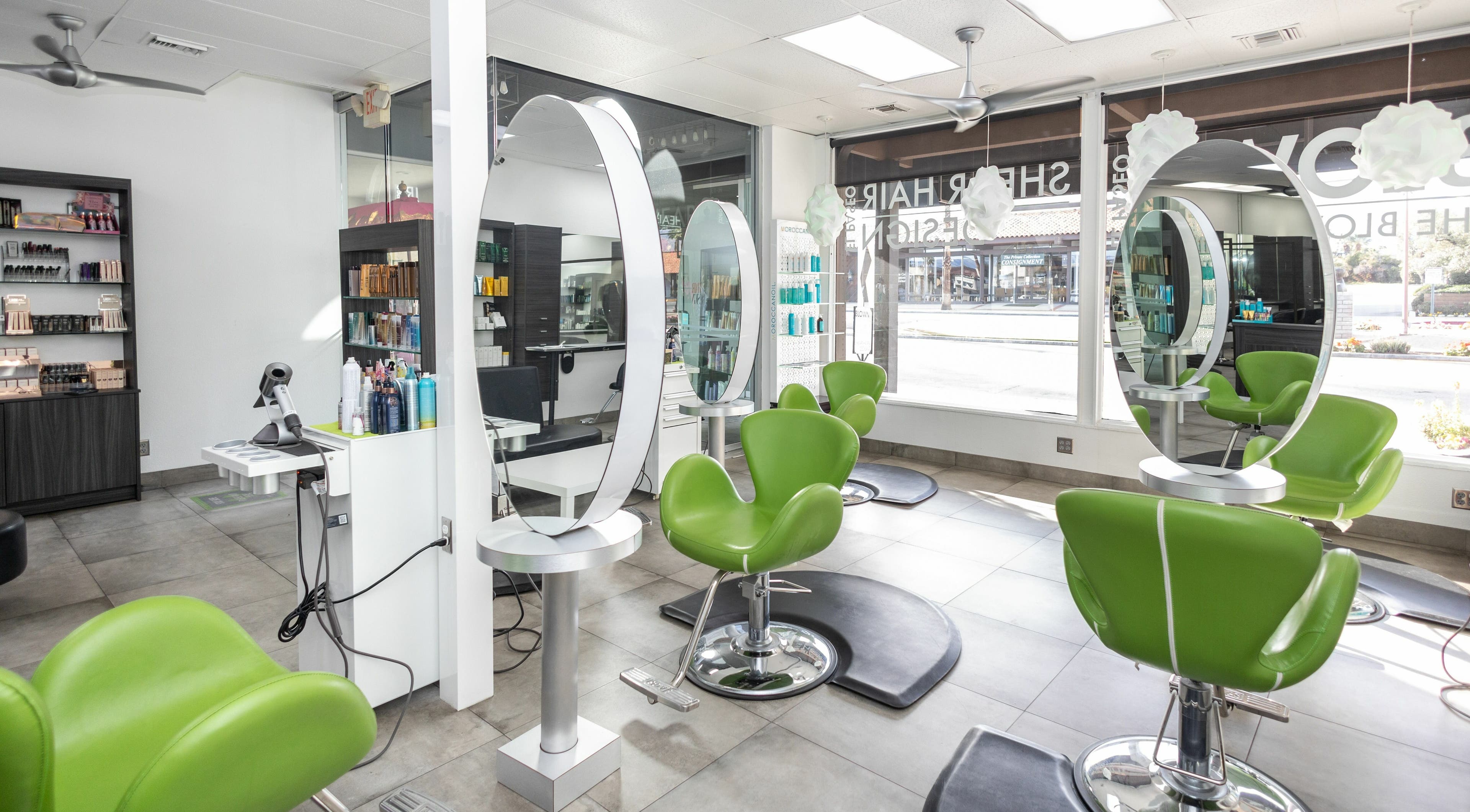 Modern salon at Blown El Paseo at Shear Hair Design, featuring sleek green chairs in Palm Desert, California, US.