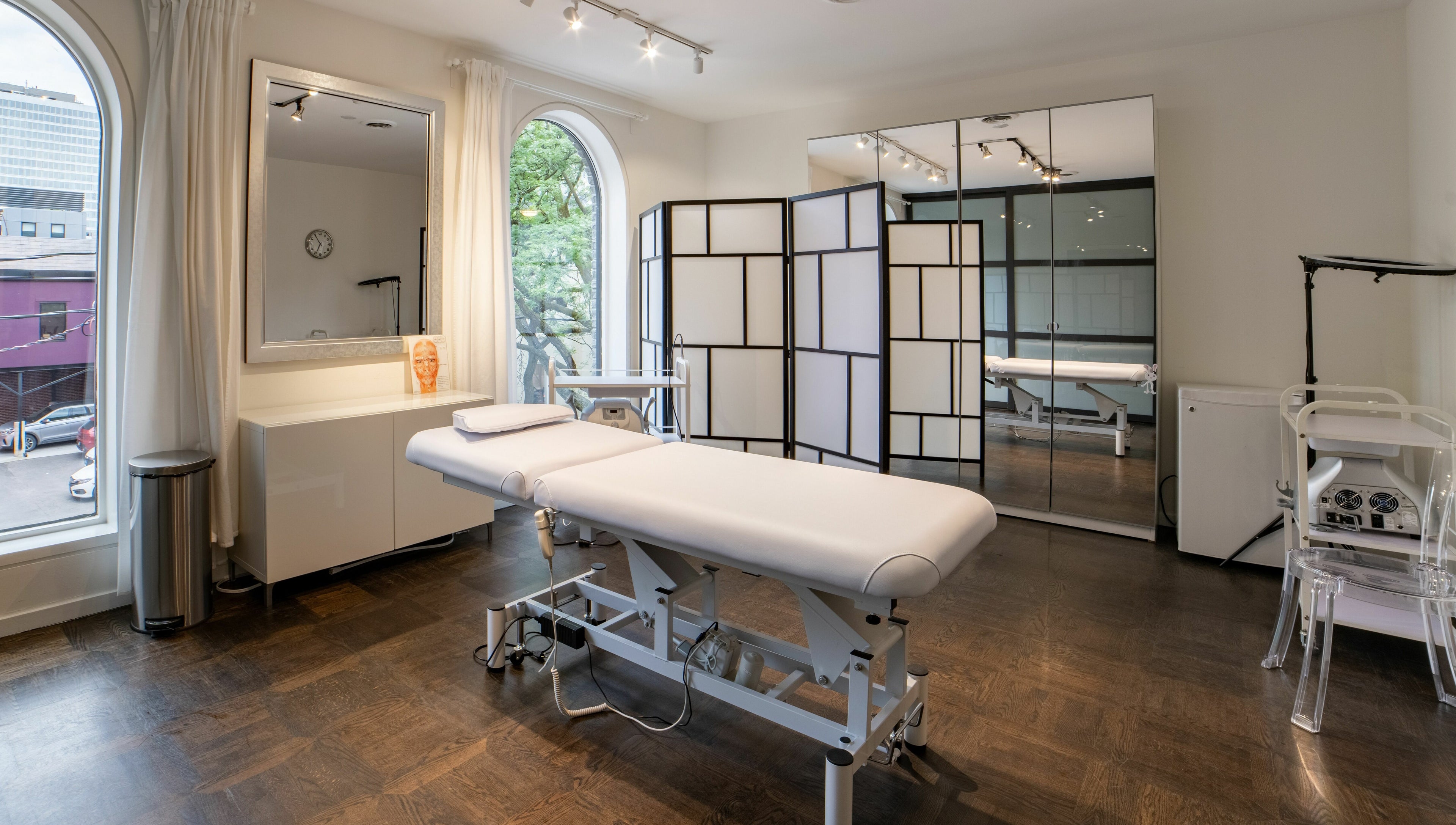 Spacious treatment room at MedVSpa, Toronto, Ontario, CA, featuring a comfortable massage table and elegant decor.