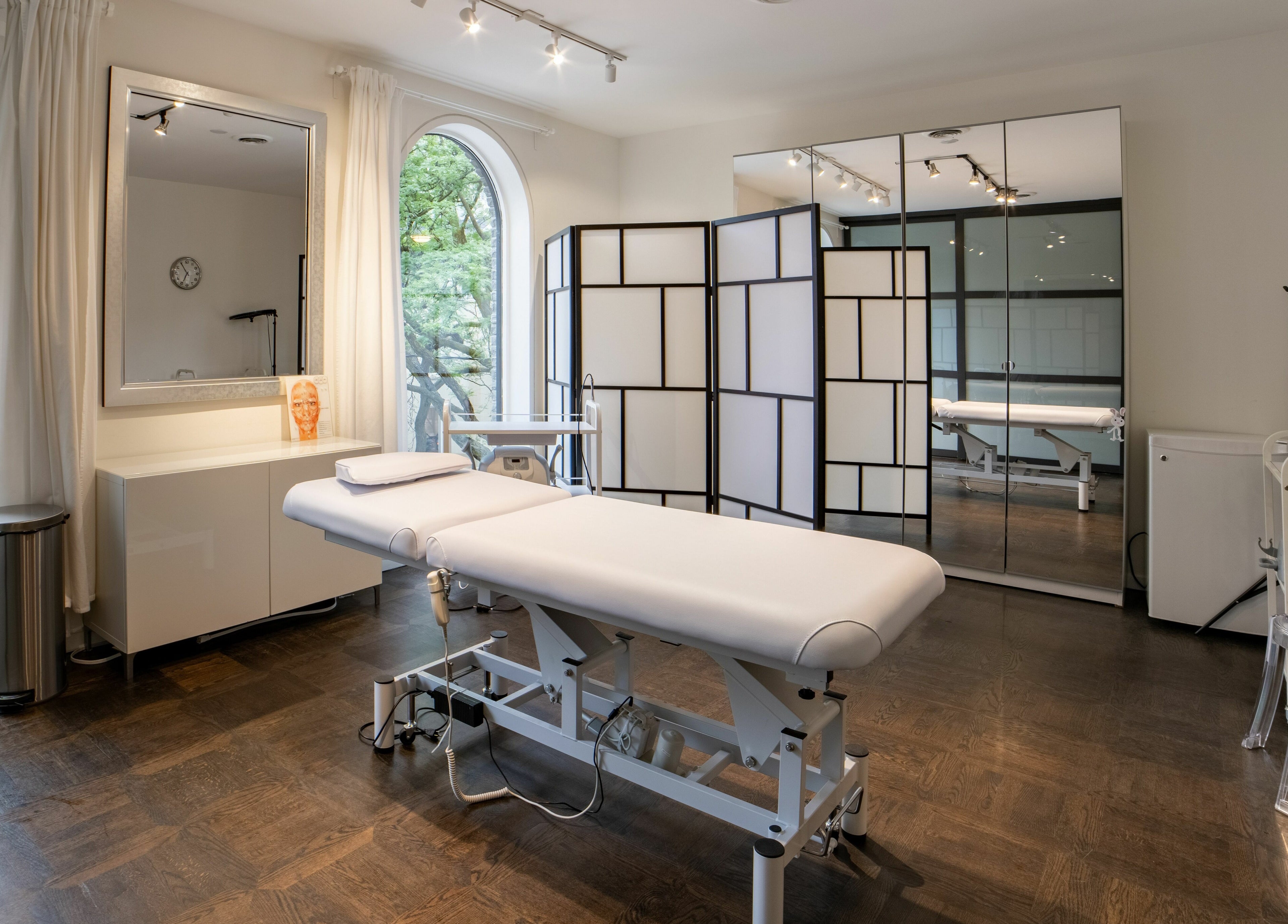 Spacious treatment room at MedVSpa, Toronto, Ontario, CA, featuring a comfortable massage table and elegant decor.