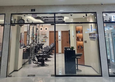 Elegant interior of Pitstop Barbers in Dubai, AE, featuring stylish chairs and grooming stations.