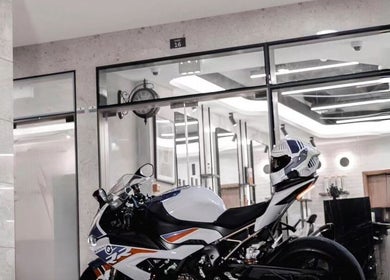Interior of Pitstop Barbers in Dubai, AE featuring a sleek motorcycle for a stylish ambiance.